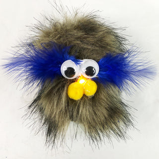 A Brown Fur TapeBlock with Large googly eyes  and yellow pom pom cheeks and Blue tuffs near the eyes and a yellow light up nose 