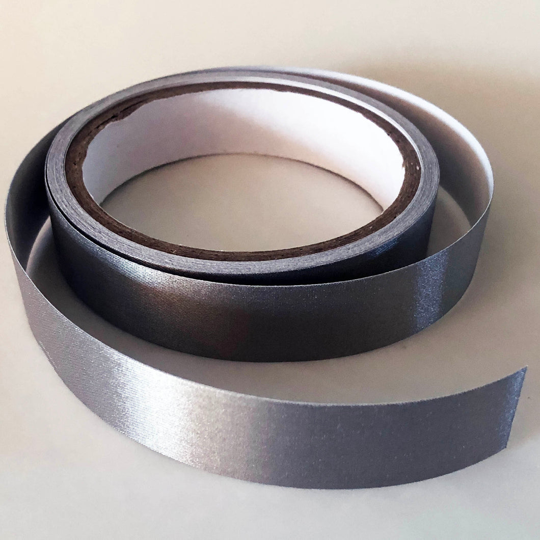 A 5 meter roll of conductive tape, The core of the roll is 7cm and the tape is 2cm wide. The roll is open