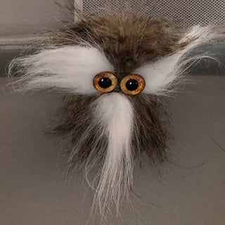 A Brown Fur TapeBlock with Large yellow glass eyes and a white moustache and tuffs near the eyes 