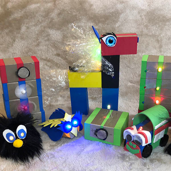A display of TapeBlock piles and characters. In the middle is a penguin, bird, horse, and train.