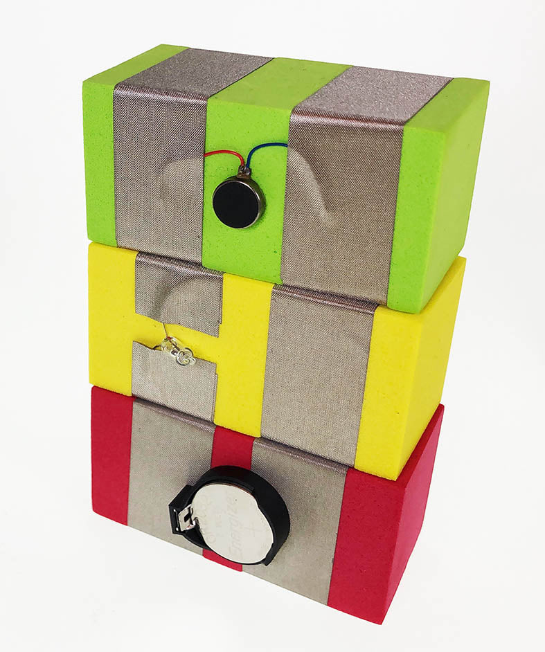 Stack of TapeBlocks, Red Power at the bottom, Yellow tilt switch in the middle and green vibration TapeBlock at the top