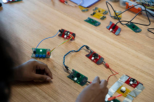 Several PCBs connected together with banana plugs, alligator clips and conductive tape