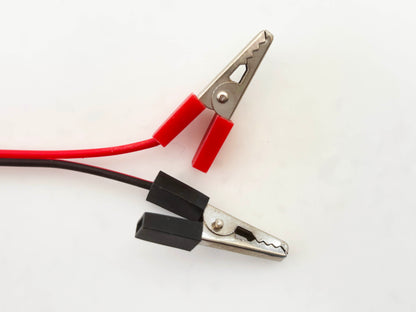 Custom alligator clip with red and black leads on a white background