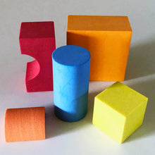Load image into Gallery viewer, Odd shaped and colored foam blocks including: Red arch, orange shape with a square face and rectangle top, blue cylinder, orange small half cylinder and yellow square cube
