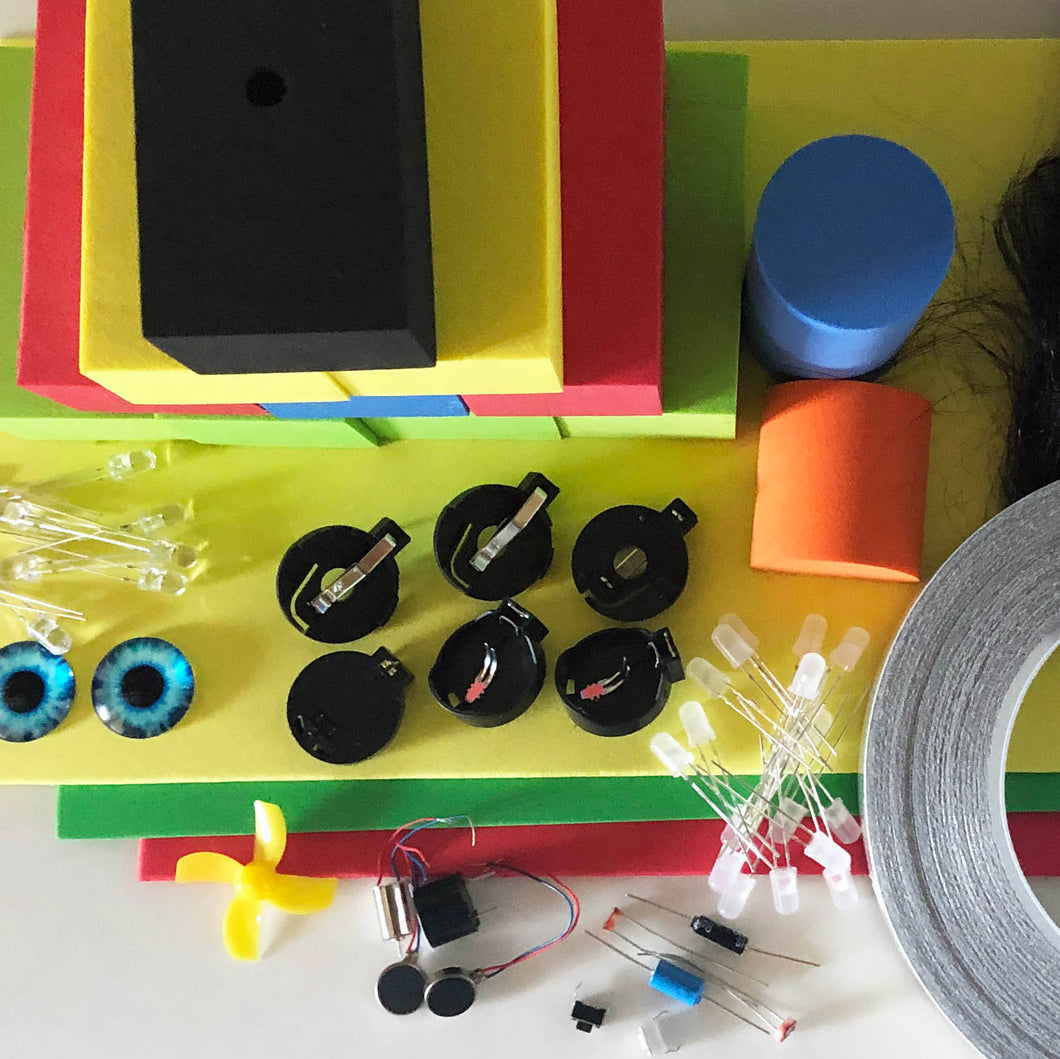 Contents of the TapeBlock making kit in a pile including Foam Blocks and sheet foam, LEDs, switches, motors and conductive tape, fur and eyes are included.
