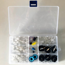 Load image into Gallery viewer, Contents of the TapeBlock making components in a plastic box. Including LEDs, switches, motors, eyes (blue glass) and battery holders all in separate sections.

