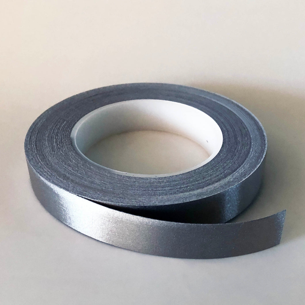 A roll of conductive tape, The core of the roll is 7cm and the tape is 2cm wide. The roll is open