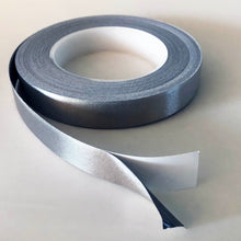 Load image into Gallery viewer, A Role of conductive tape which is open. There is an inch at the end showing the silver conductive tape separated from the white backing.
